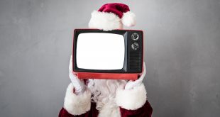 Santa Claus holding retro TV